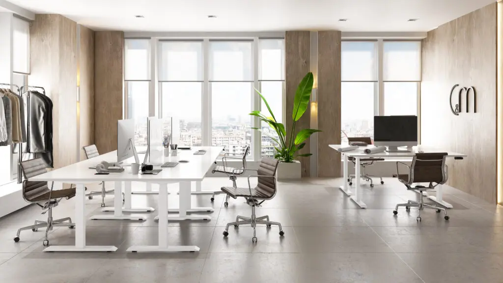 open office area with white height-adjustable bases and chairs