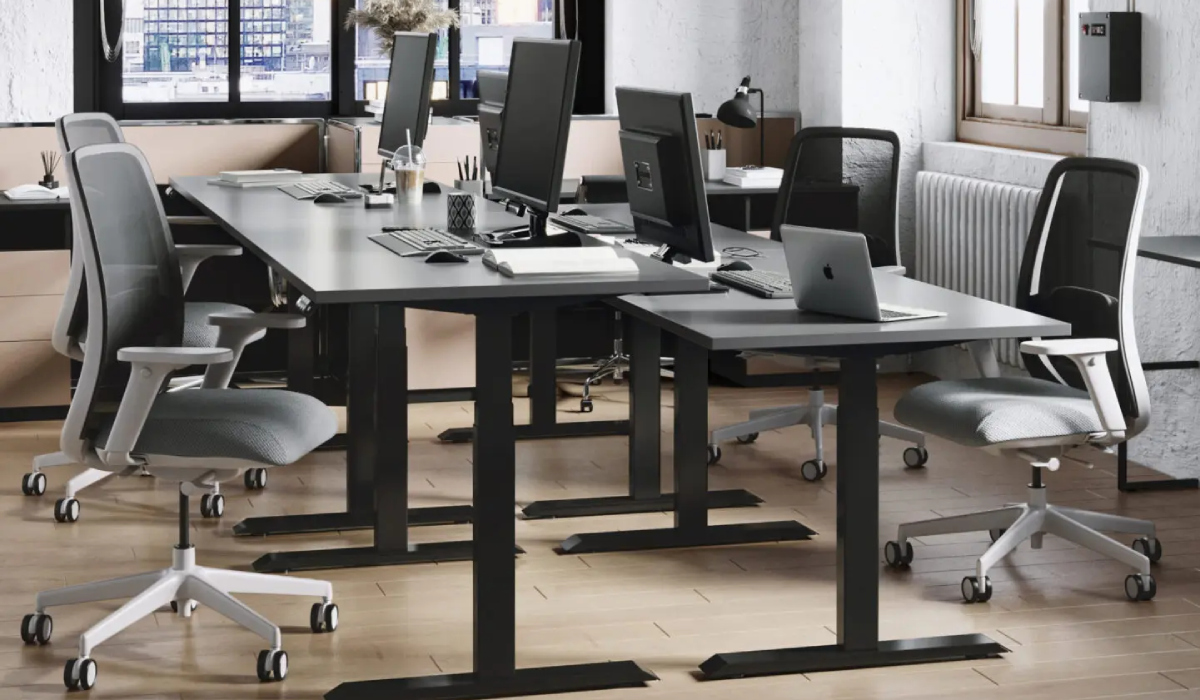 black height-adjustable bases with grey tops and computers on top