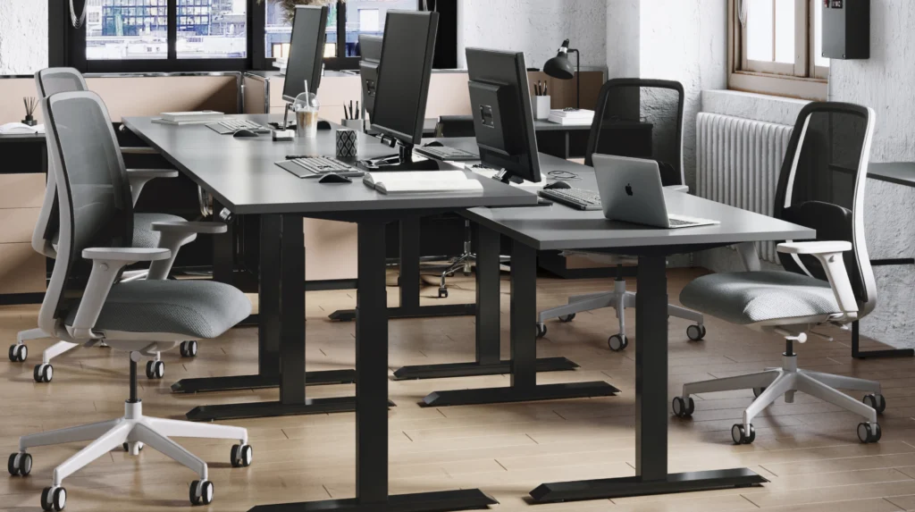 corner of office with four height-adjustable bases and chairs